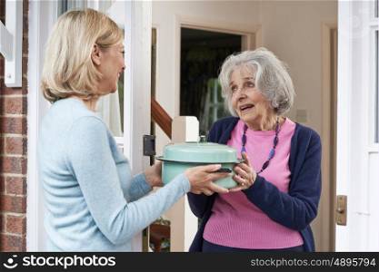 Woman Bringing Meal For Elderly Neighbour