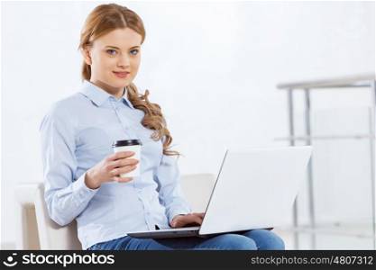 Woman browsing web. Young pretty businesswoman sitting and using laptop