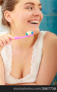 woman brushing cleaning teeth. Girl with toothbrush in bathroom.. Young woman brushing cleaning teeth. Girl with toothbrush in bathroom. Oral hygiene.