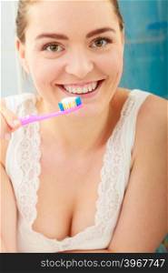 woman brushing cleaning teeth. Girl with toothbrush in bathroom.. Young woman brushing cleaning teeth. Girl with toothbrush in bathroom. Oral hygiene.