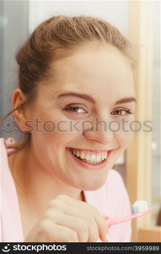 Woman brushing cleaning teeth in bathroom. Woman brushing cleaning teeth. Girl with toothbrush in bathroom. Oral hygiene.