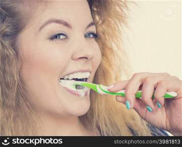 Woman brushing cleaning teeth. Positive girl with toothbrush. Oral hygiene.. Woman brushing cleaning teeth