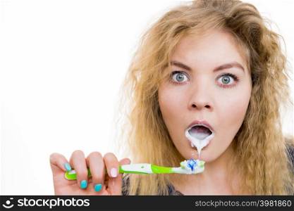 Woman brushing cleaning teeth. Shocked girl with toothbrush. Oral hygiene. Studio shot on white background. Woman brushing cleaning teeth