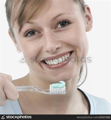 woman brushing her teeth, studio white