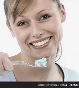 woman brushing her teeth, studio white
