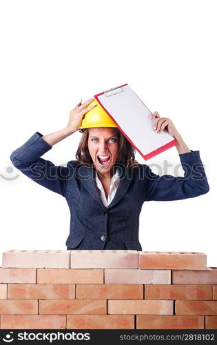 Woman builder and brick wall