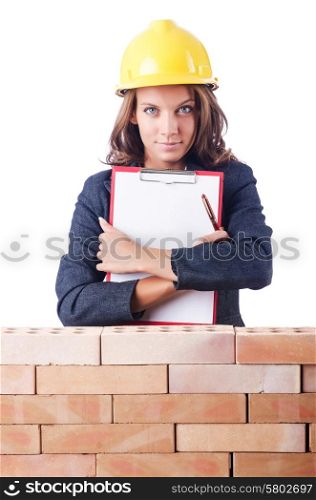 Woman builder and brick wall