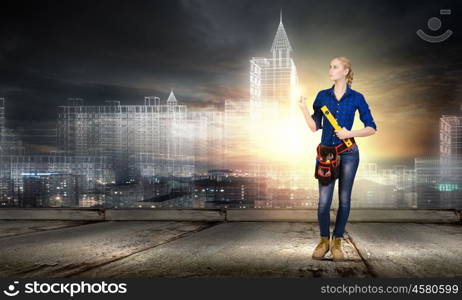 Woman builder. Close up of woman builder with ruler in hands