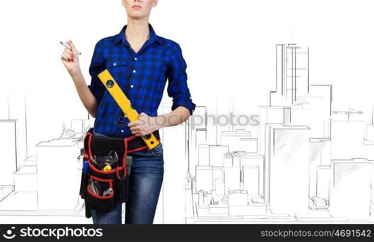 Woman builder. Close up of woman builder with ruler in hands
