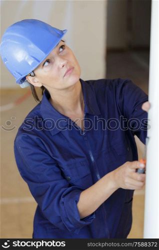 woman builder looking at the wall