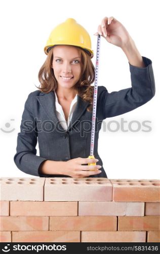 Woman builder measuring isolated on the white