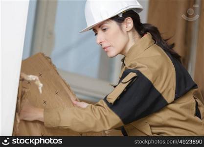 woman builder removing a part of the wall