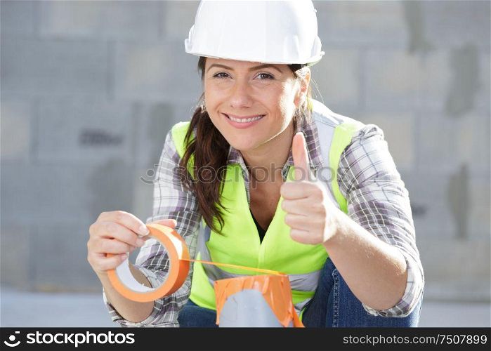 woman builder shows thumb up