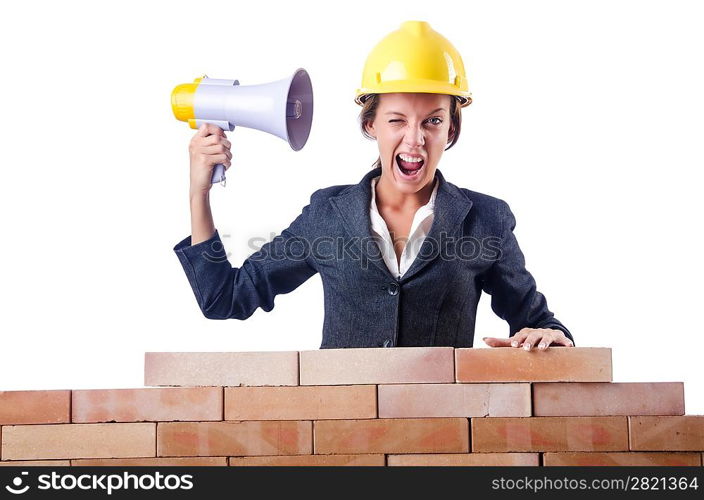 Woman builder with loudspeaker on white