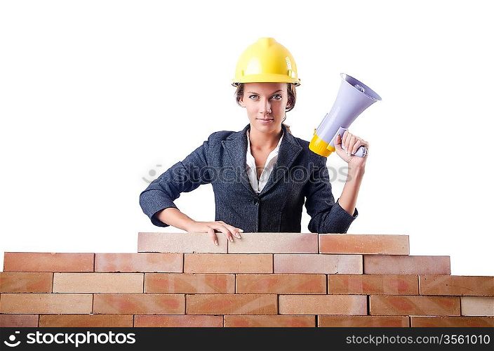 Woman builder with loudspeaker on white