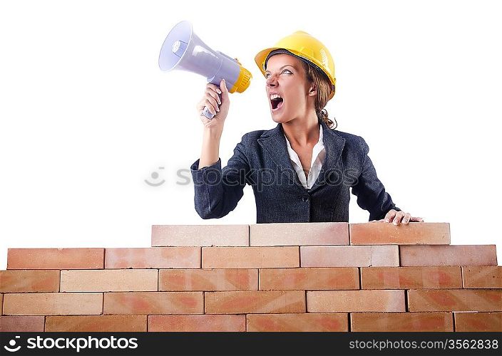 Woman builder with loudspeaker on white