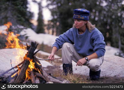 Woman Building a Campfire