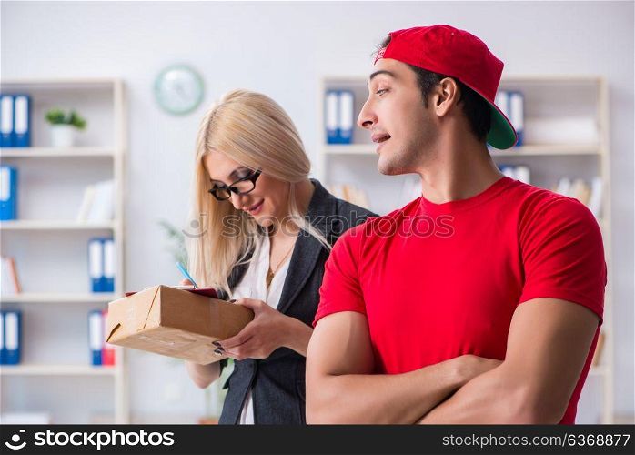 Woman businesswoman receiving mail parcel from courier