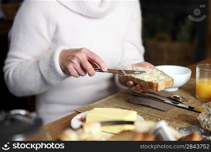Woman buttering bread