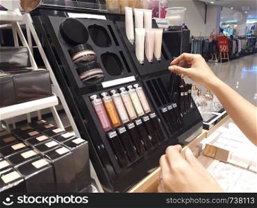 Woman buying cosmetics in shopping mall, Beauty concept