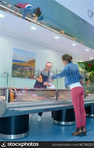 Woman buying fresh goods from counter