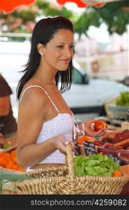 Woman buying fruit and vegetables at outdoors market