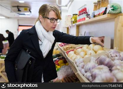 woman buying fruits and vegetables at local food market