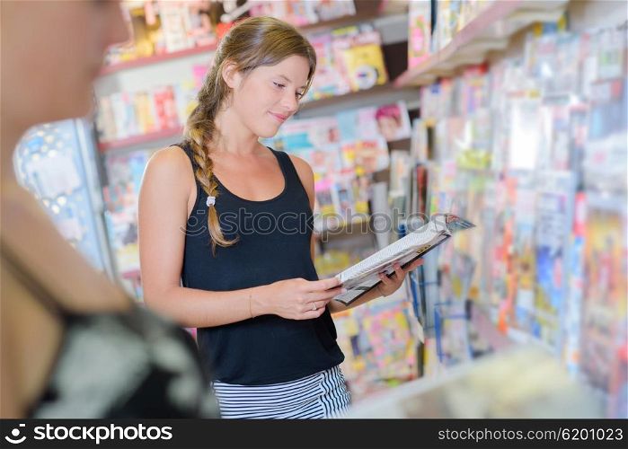 woman buying magazines