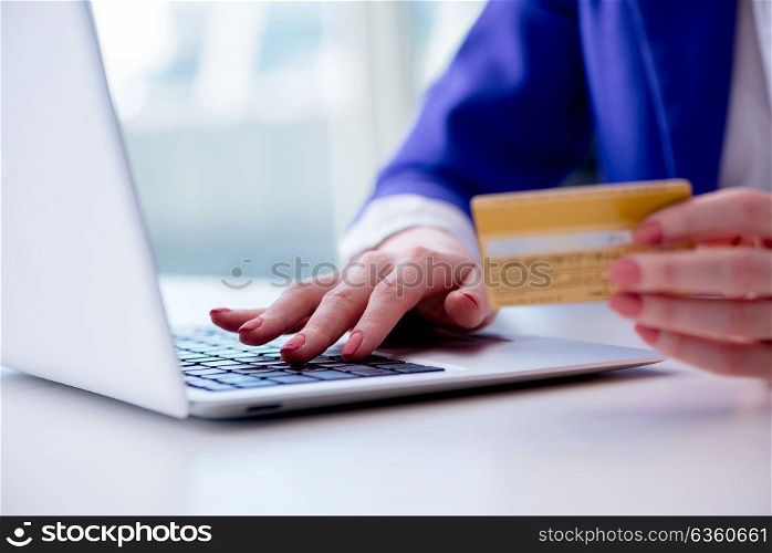 Woman buying online with credit plastic card. The woman buying online with credit plastic card