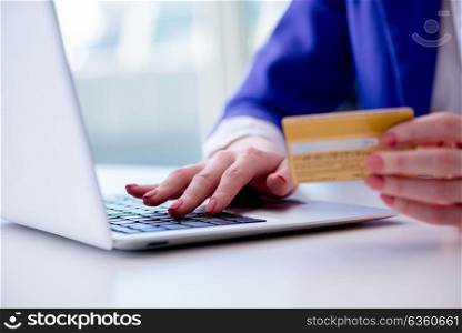 Woman buying online with credit plastic card. The woman buying online with credit plastic card