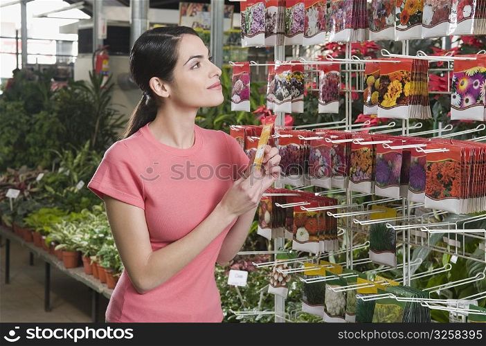 Woman buying seed packets in a store