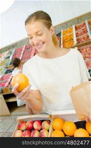 Woman buying some oranges