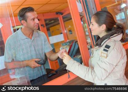 Woman buying ticket from booth