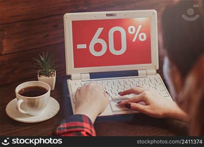 Woman buys online using laptop. Online shopping. Sale and seasonal discounts. Black Friday concept.. Woman buys online using laptop. Online shopping. Sale, seasonal discounts. Black Friday concept.