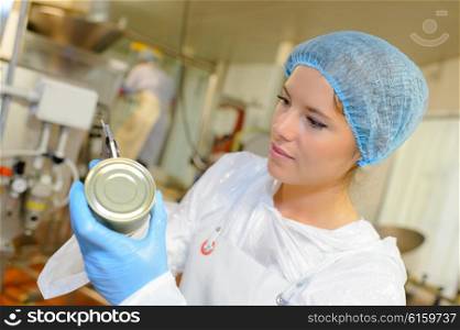 woman calibrating tin goods