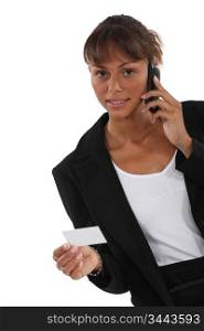Woman calling number on business card