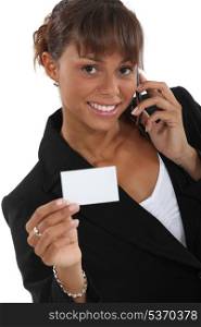 Woman calling number on business-card