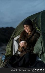 woman camping holding cup tea