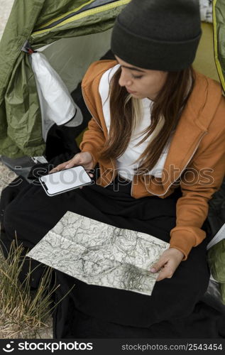 woman camping looking map high view