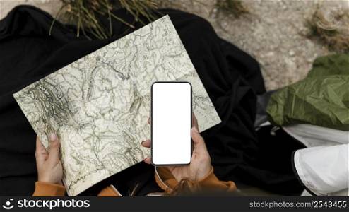 woman camping looking map top view