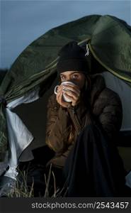 woman camping night with cup tea