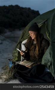 woman camping using mobile phone