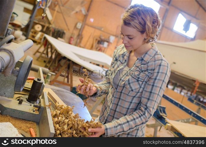 woman carpenter with wood shavings