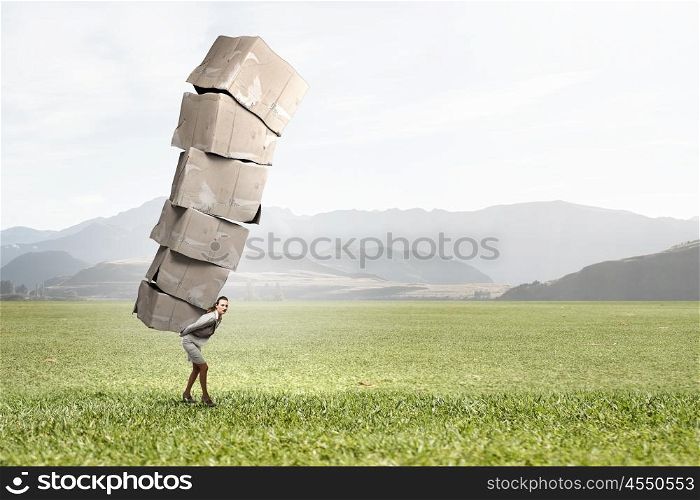 Woman carry carton boxes. Businesswoman carrying big stack of carton boxes on her back