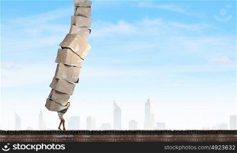 Woman carry carton boxes. Businesswoman carrying big stack of carton boxes on her back