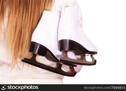 Woman carrying a pair of ice skates getting ready for ice skating, winter sport activity. Back view isolated on white