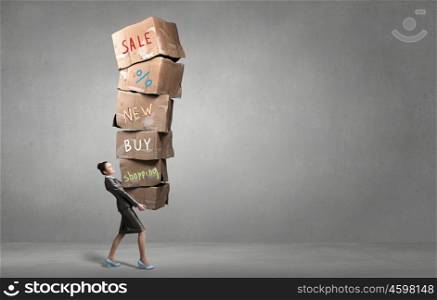 Woman carrying carton boxes. Attractive businesswoman carrying big stack of carton boxes