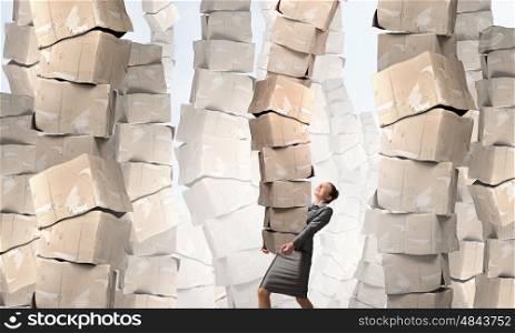 Woman carrying carton boxes. Attractive businesswoman carrying big stack of carton boxes