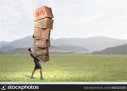 Woman carrying carton boxes. Woman in suit carrying stack of carton boxes