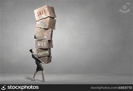 Woman carrying carton boxes. Woman in suit carrying stack of carton boxes